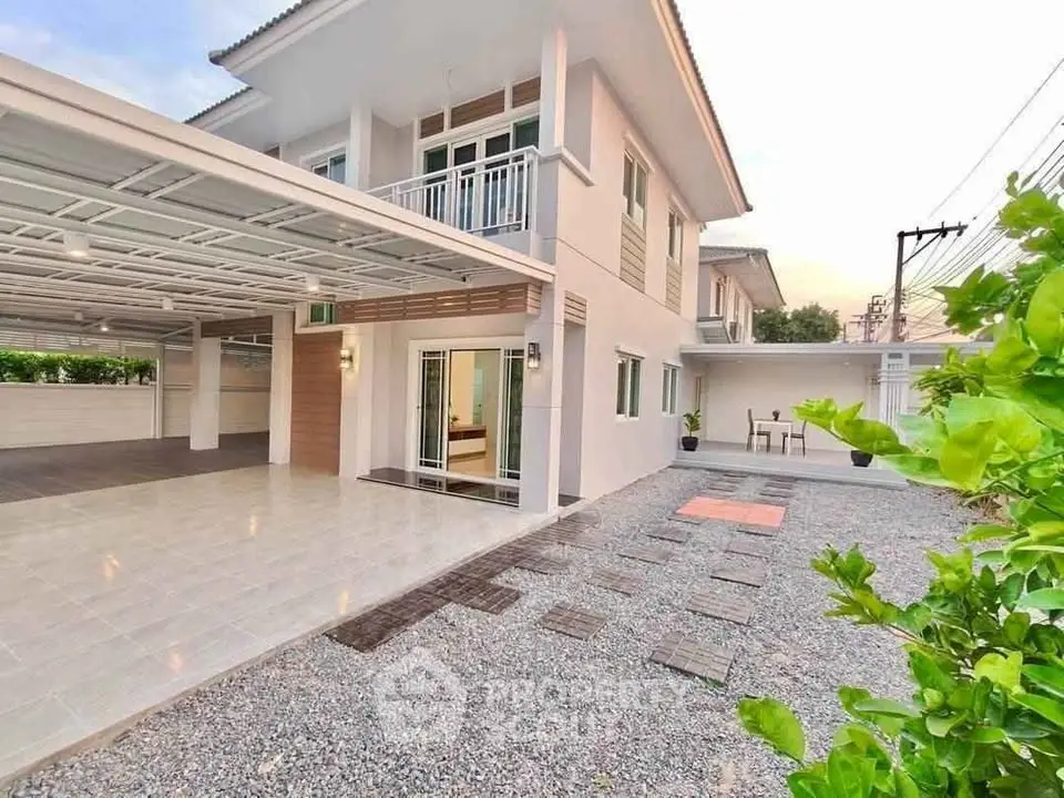 Stunning modern two-story home with spacious driveway and elegant balcony.