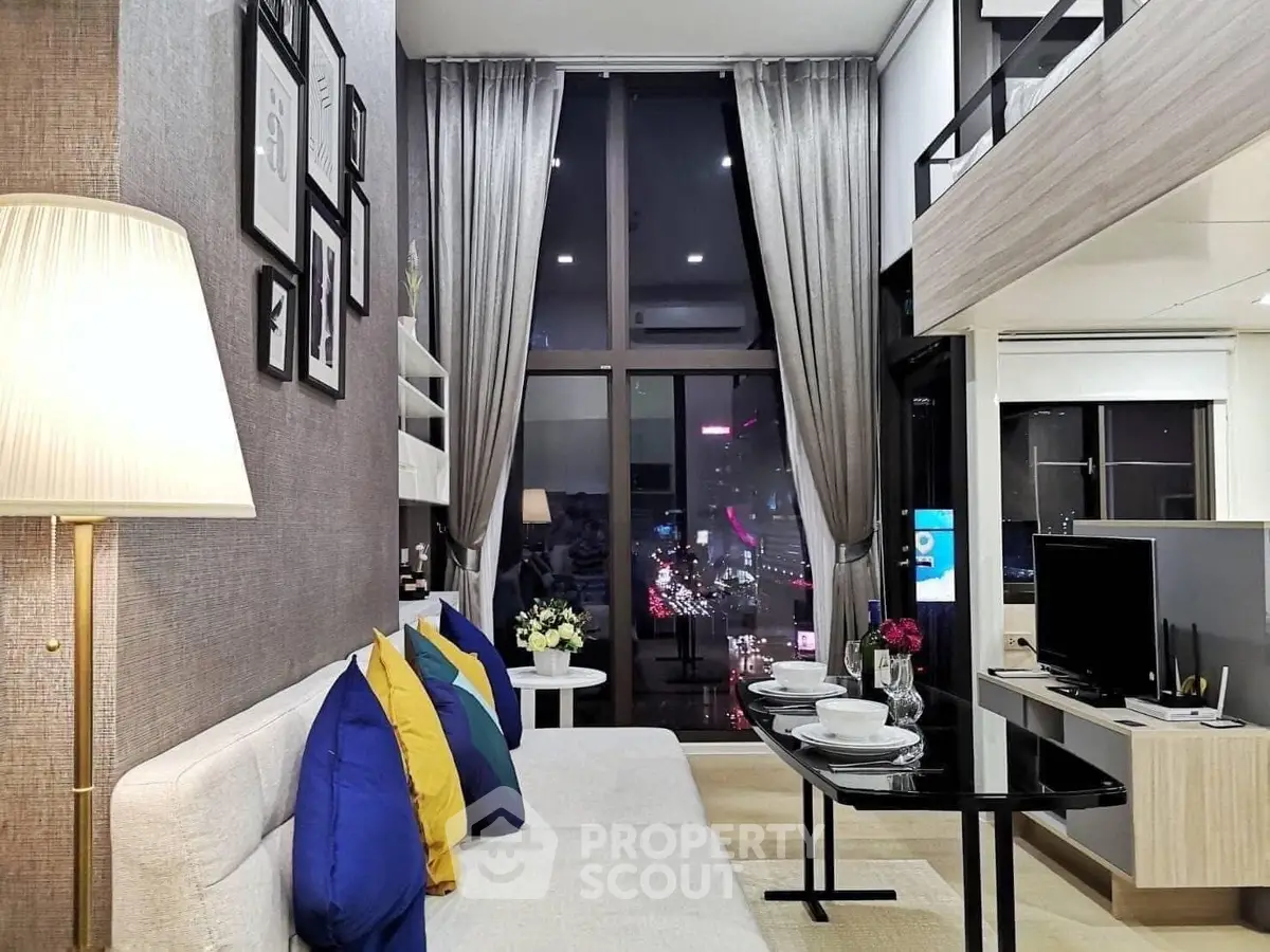 Modern living room with high ceiling and city view, featuring stylish decor and cozy seating area.
