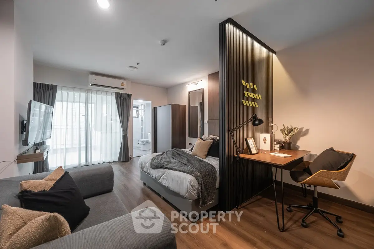 Modern studio apartment with cozy living area and stylish workspace