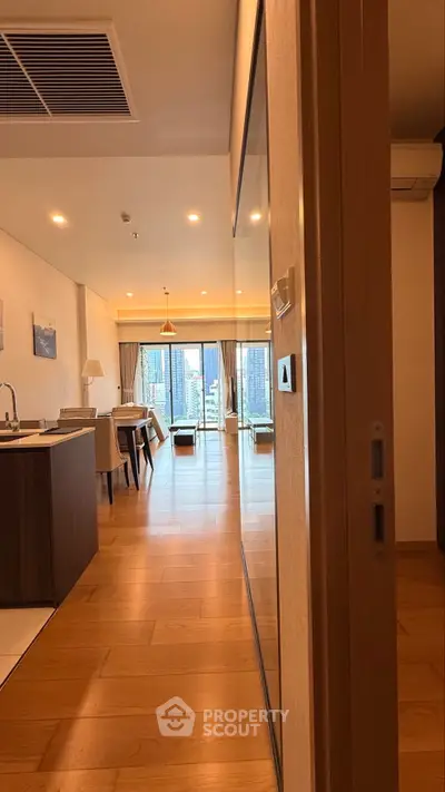 Spacious modern apartment with open layout and stunning city view, featuring elegant wooden flooring and stylish decor.