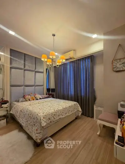 Cozy bedroom with elegant lighting and stylish decor, featuring a comfortable bed and modern furnishings.