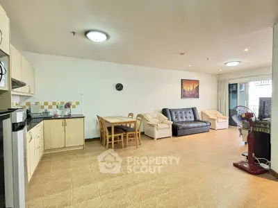 Spacious living room with modern furniture and open kitchen layout