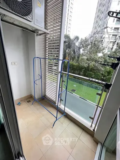 Charming balcony with lush garden view and ample space for relaxation.