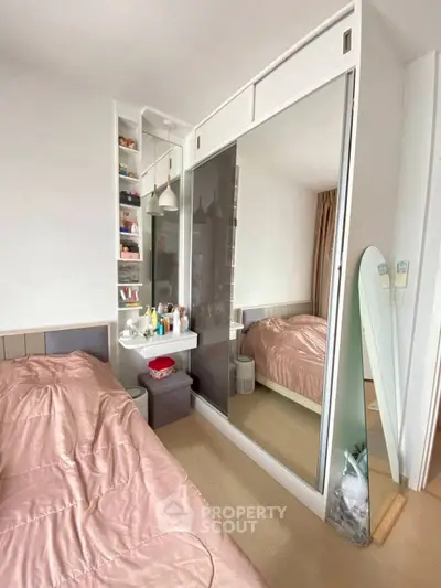 Cozy bedroom with mirrored wardrobe and stylish decor