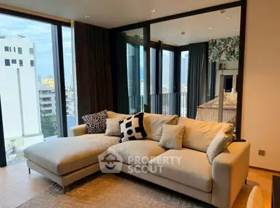 Spacious living room with modern sofa and city view balcony in luxury apartment.