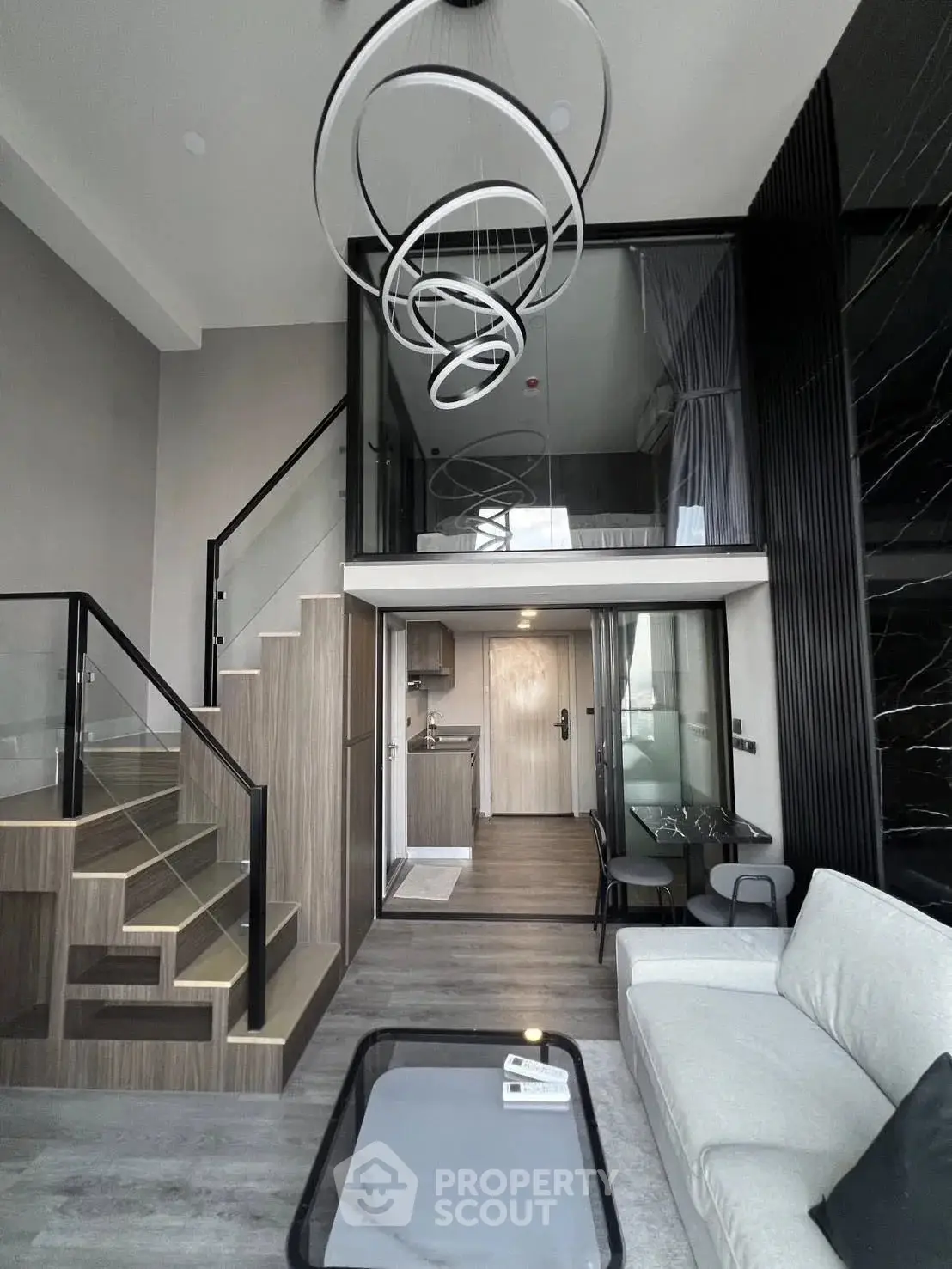 Modern duplex apartment with stylish interior and unique lighting fixtures