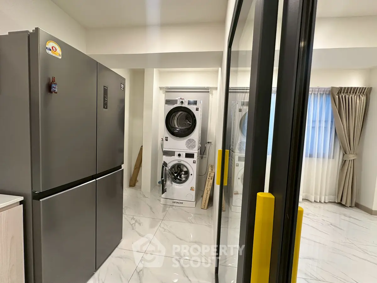 Modern laundry room with sleek appliances and marble flooring