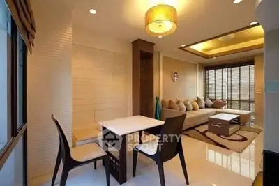 Modern living room with stylish furniture and elegant lighting, featuring a cozy dining area and large windows.