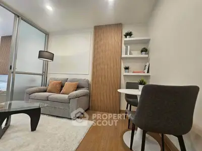 Modern living room with cozy sofa, stylish decor, and wooden accents in a chic apartment.