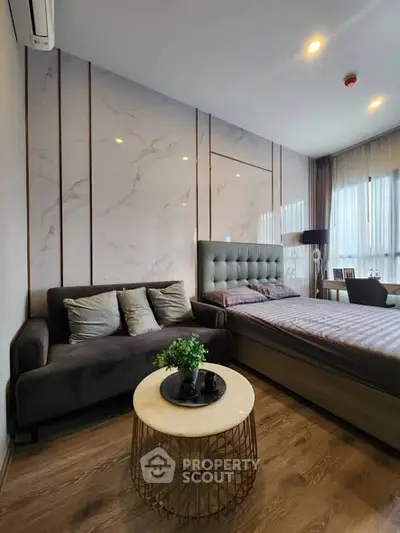 Modern bedroom with stylish decor and cozy seating area