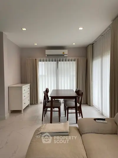 Modern living room with elegant dining area and natural light