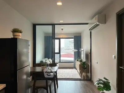 Modern apartment with open layout, featuring a cozy living area and dining space, complemented by stylish decor.