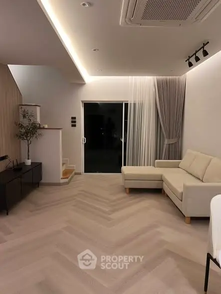 Modern living room with elegant lighting and cozy sectional sofa