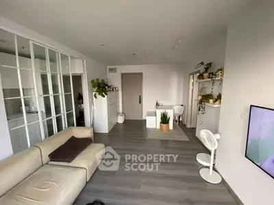 Modern living room with sleek design, featuring a cozy sofa and stylish decor, perfect for urban living.