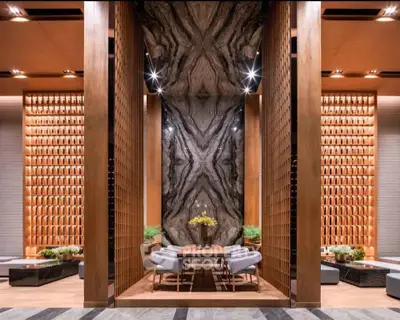 Luxurious modern interior with elegant wood paneling and striking marble feature wall, perfect for upscale living.