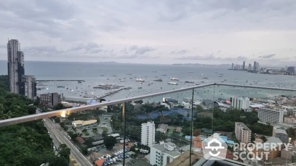 Stunning high-rise balcony view overlooking cityscape and ocean horizon