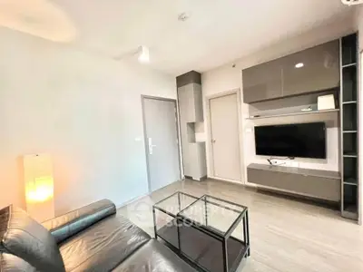 Modern living room with sleek furniture and mounted TV in a stylish apartment.