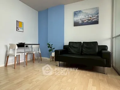 Modern living room with black sofa, dining table, and stylish decor