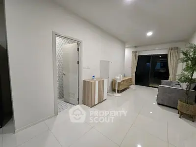 Spacious modern living room with sleek white tiles and stylish furniture