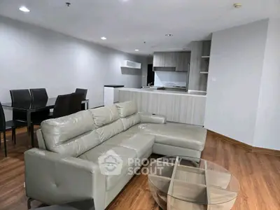 Modern living room with sleek furniture and open kitchen layout