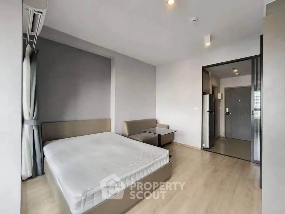 Modern studio apartment with cozy bed and stylish decor