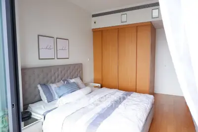 Modern bedroom with stylish decor and ample natural light