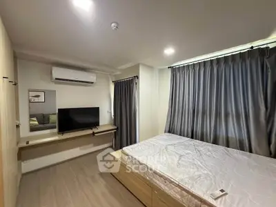 Modern bedroom with sleek design, featuring a wall-mounted TV, air conditioning, and elegant curtains.