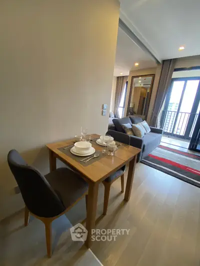 Modern living room with dining area and balcony view in a stylish apartment