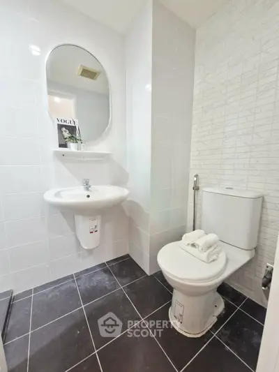 Modern bathroom with sleek white tiles and contemporary fixtures