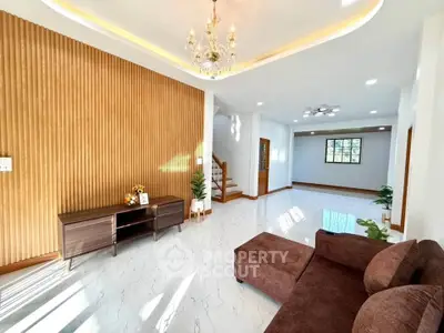 Spacious modern living room with elegant chandelier and stylish wooden accents