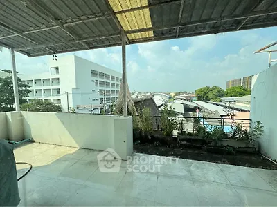 Spacious balcony with urban view, perfect for relaxation and enjoying cityscape.