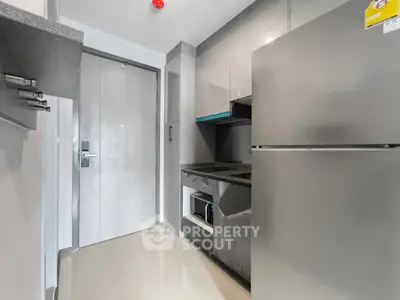Modern kitchen with sleek appliances and minimalist design in a contemporary apartment.