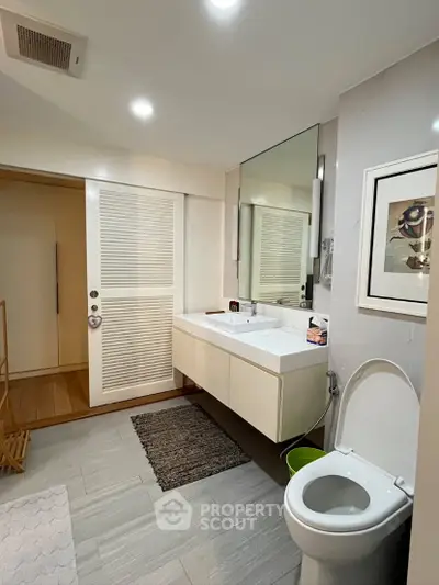Modern bathroom with sleek fixtures and stylish decor in a contemporary home.