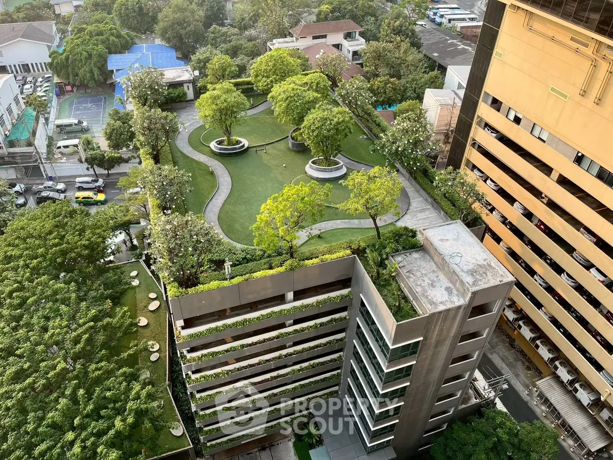 Stunning aerial view of a modern building with lush rooftop garden and cityscape backdrop.