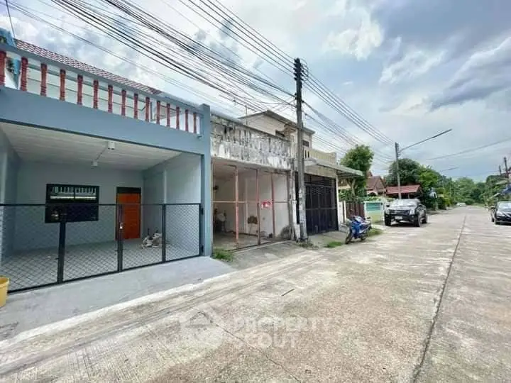 Charming residential street view with houses and parked vehicles, ideal for family living.