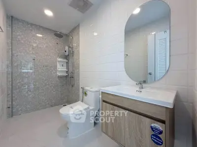 Modern bathroom with sleek fixtures and spacious shower area