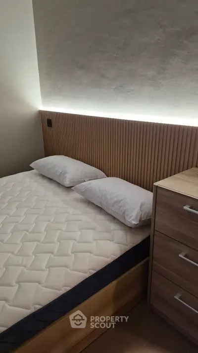 Modern bedroom with stylish wooden headboard and cozy lighting