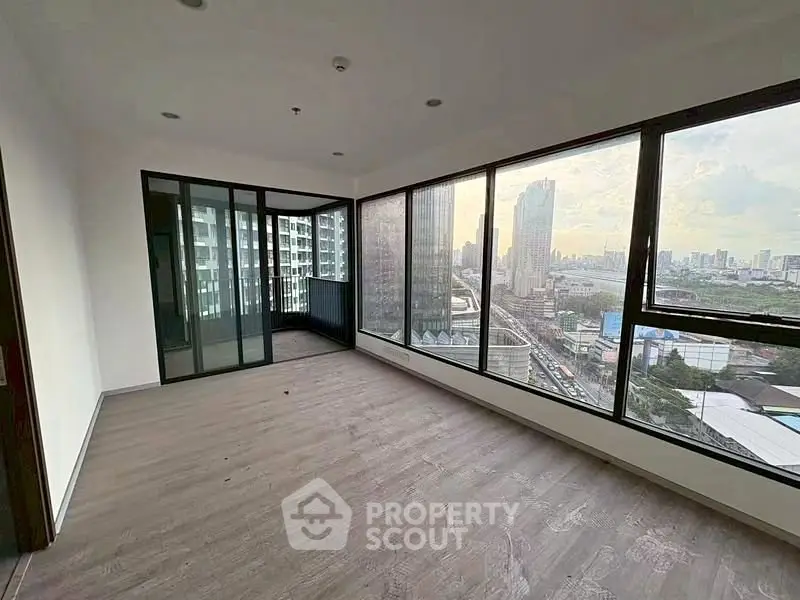Spacious corner unit with floor-to-ceiling windows offering stunning city views in a modern high-rise building.