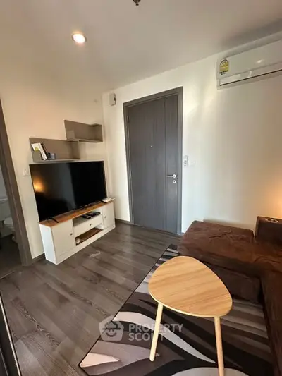 Modern living room with sleek furniture and flat-screen TV, perfect for cozy relaxation.