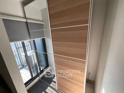 Modern apartment with sleek wardrobe and balcony view, perfect for urban living.