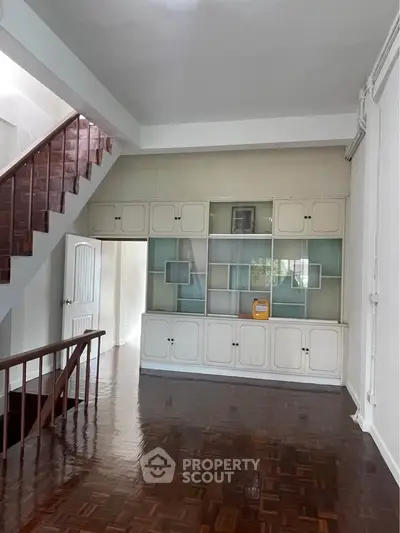 Spacious living room with wooden flooring and built-in storage