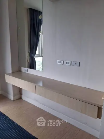 Modern minimalist interior with floating desk and large mirror, perfect for a stylish home office setup.
