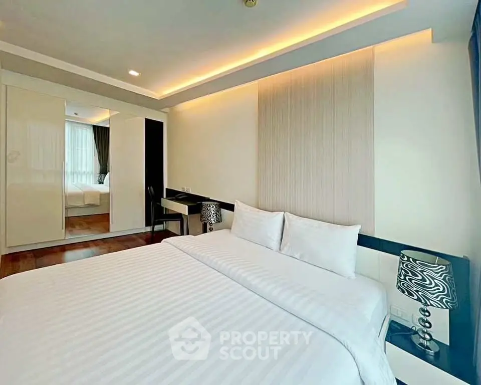 Luxurious bedroom with modern decor and ambient lighting, featuring a comfortable king-size bed and stylish furnishings.