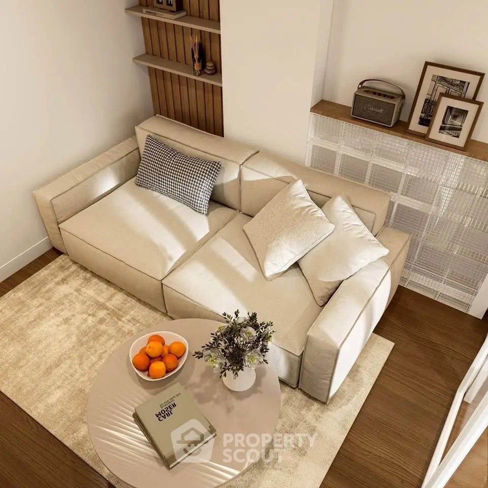 Stylish living room with modern beige sofa, cozy decor, and elegant wooden flooring.