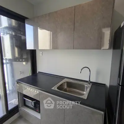 Modern kitchen with sleek cabinets and built-in appliances in a stylish apartment.