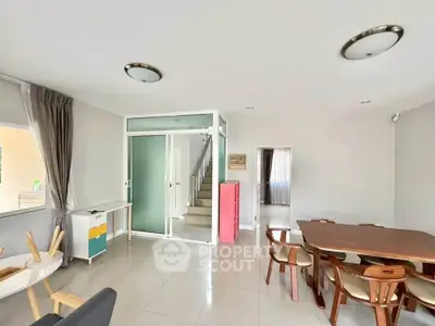 Spacious modern living room with dining area and staircase in elegant home