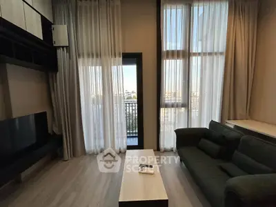 Modern living room with high ceilings and balcony view