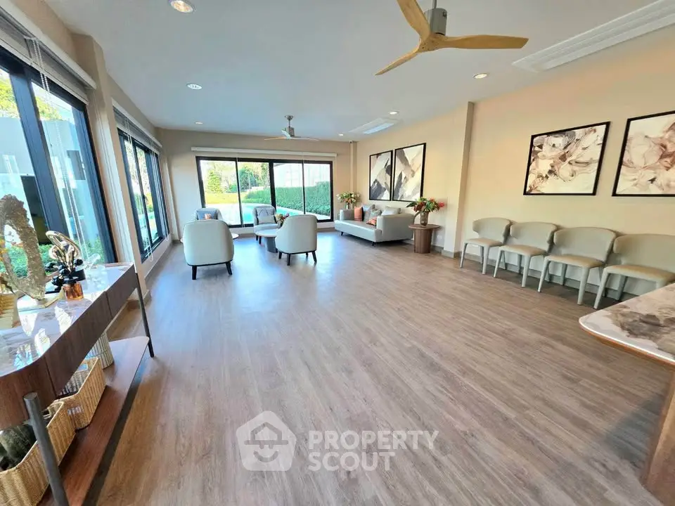 Spacious modern living room with elegant decor and large windows for natural light.