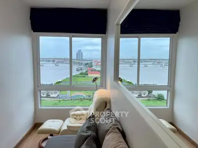 Stunning river view from modern living room with cozy seating area.