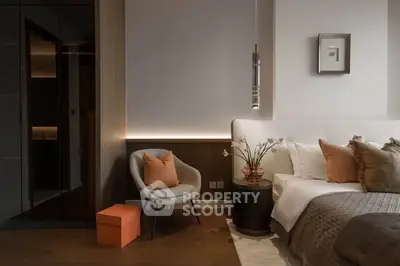 Luxurious modern bedroom with elegant decor and cozy seating area.